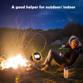 Person sitting by a campfire with a lantern and tent in the background, text 'A good helper for outdoor/indoor'.